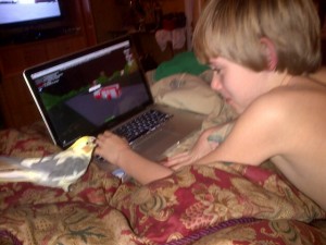 My son, our bird , and his Mac.